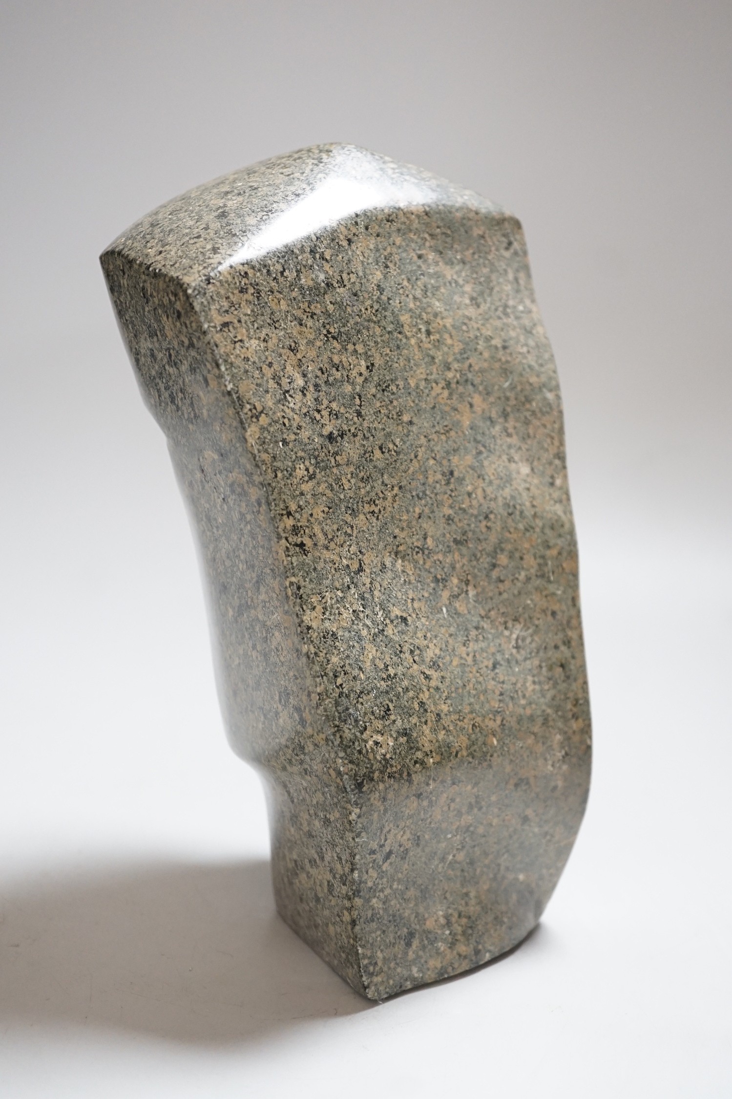 A carved stone head, 23cms high